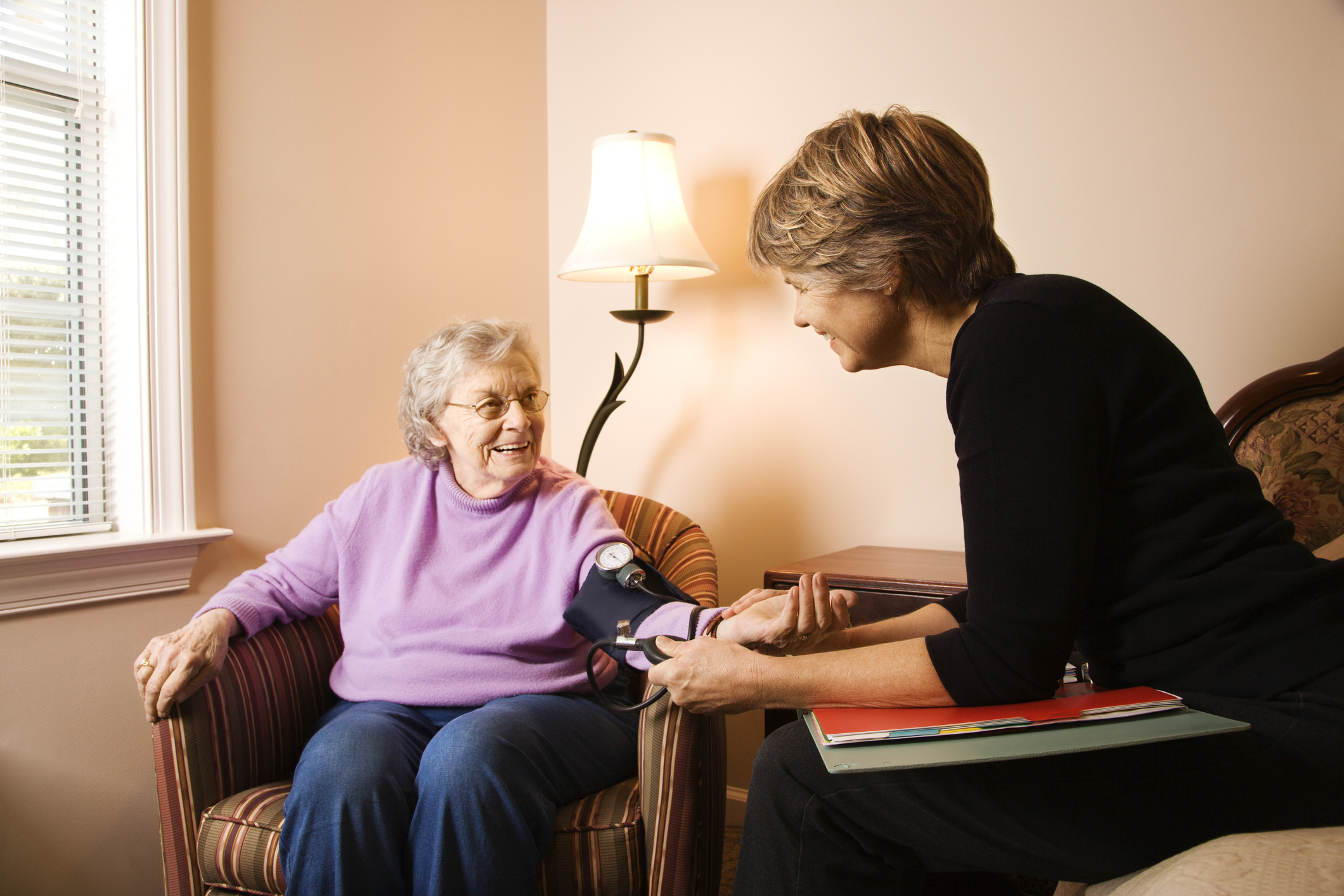 elderly-woman-having-blood-pressure-taken-12619878